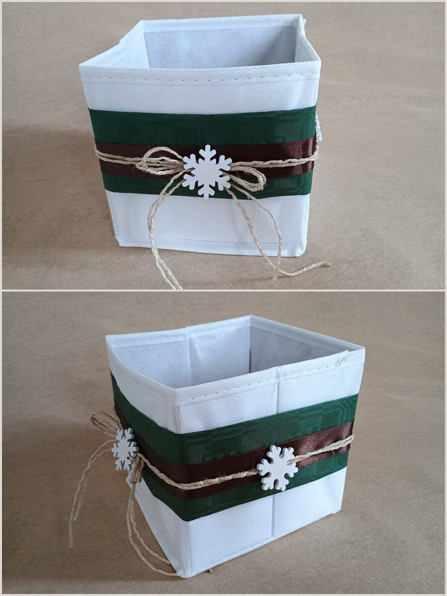 Stoffbox mit Banderole aus Papier, Band, Schnur und Holz-Schneeflocken in Weiß, Grün und Braun